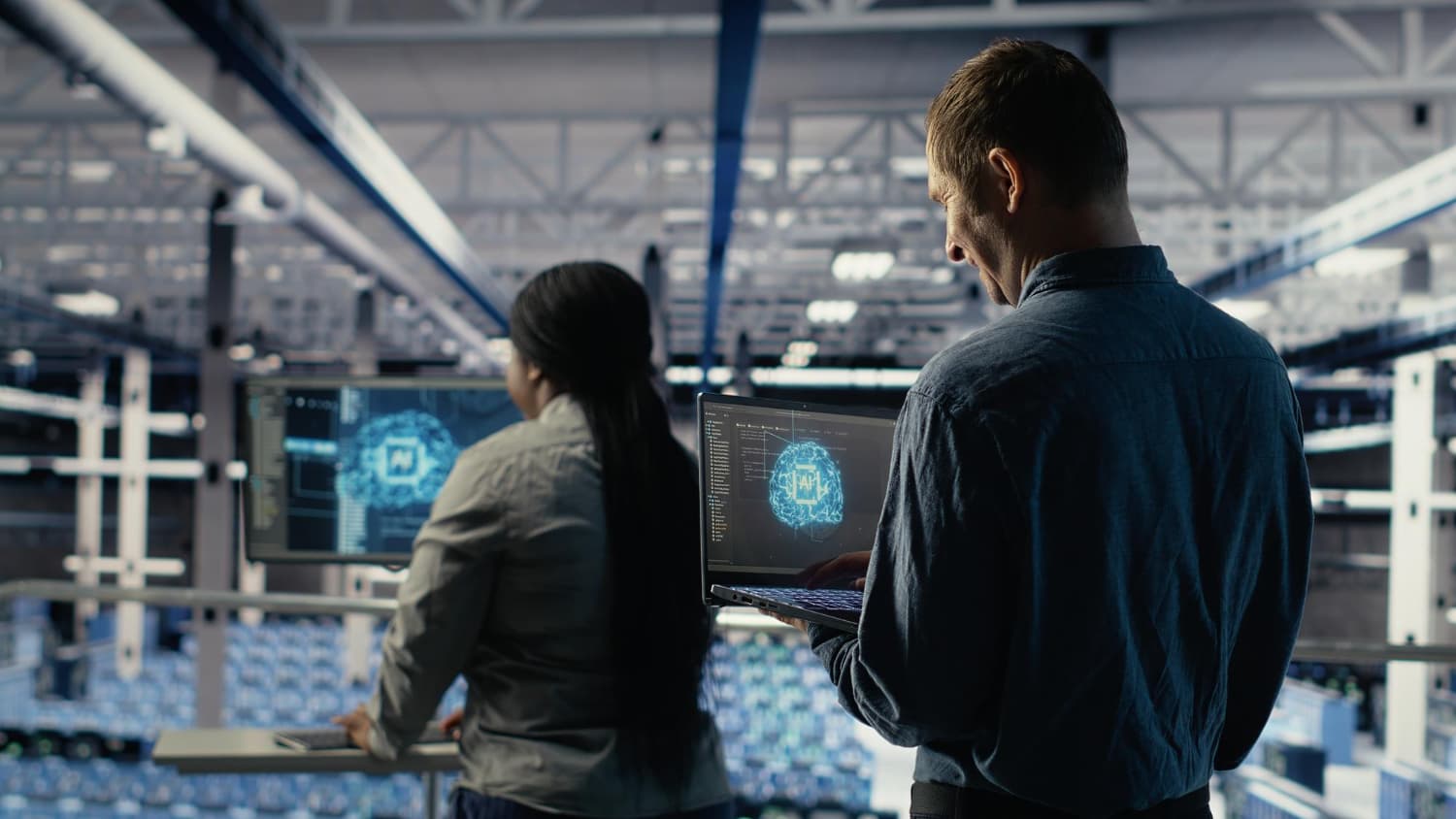 Hand interacting with a holographic display of AI and automation icons over a manufacturing line