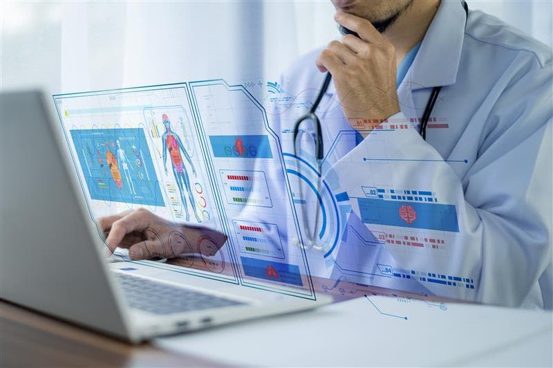 Clinician reviewing patient data on a digital healthcare dashboard